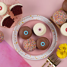 Load image into Gallery viewer, Red Velvet, Vanilla, Dark Chocolate, and Sprinkle cupcakes on a plate. not-bg
