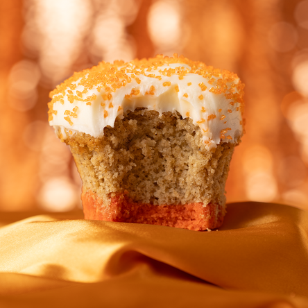 chai cake with a orange sugar cookie crust and topped with vanilla butter cream and topped with orange sugar crystals