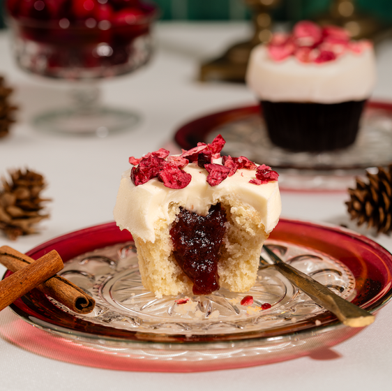 Spiced Cranberry Vanilla Cupcake on a plate with festive decorations