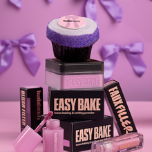 Load image into Gallery viewer, Huda beauty cupcake on top of Huda beauty products not-bg
