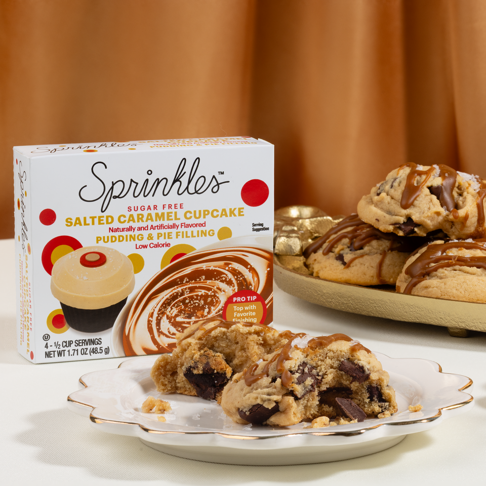 Sprinkles salted caramel cupcake pudding package with cookies on a plate and in the background.