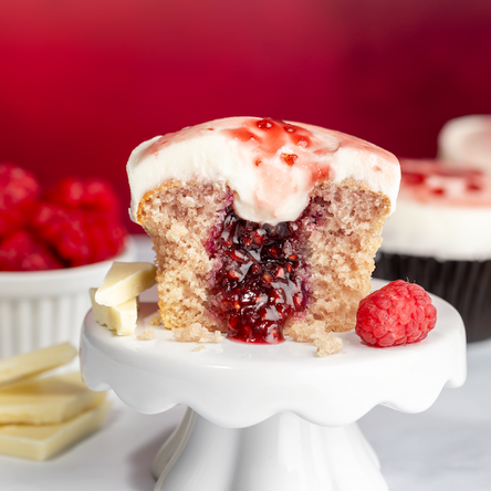 white chocolate raspberry cupcake with raspberry filling. not-bg