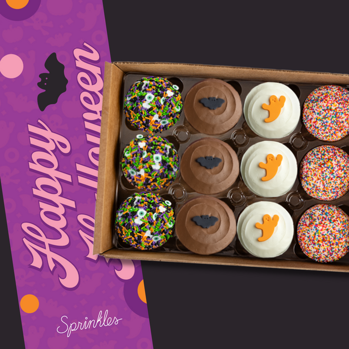 Box of Halloween-themed cupcakes with a purple 'Happy Halloween' giftwrap