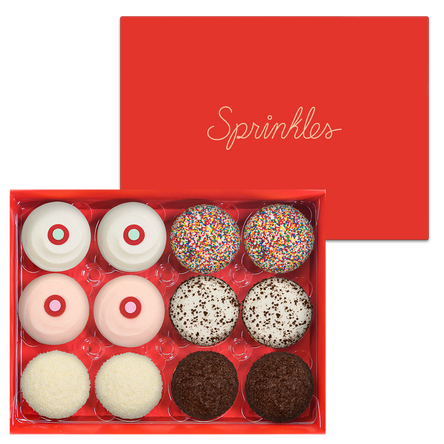 Assorted Dozen Red Box includes 2 Red Velvet, 2 Strawberry, 2 Vanilla, 2 Sprinkles, 2 Black & White, and 2 Dark Chocolate cupcakes.