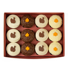 Load image into Gallery viewer, gratitude dozen box with pumpkin, dark chocolate, red velvet and vanilla with Thanksgiving themed decorations not-bg
