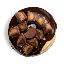Load image into Gallery viewer, top of Reece&#39;s®  Peanut Butter Cup cupcake with peanut butter frosting, chocolate ganache and finished off with mounds of mini Reese&#39;s® Peanut Butter Cups not-bg
