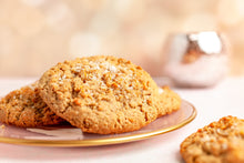 Load image into Gallery viewer, Sprinkles salted oatmeal cookies stacked on a plate. not-bg
