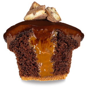 half of a twix cupcake with a cookie crust lined chocolate cake, caramel filling, chocolate cream cheese frosting, a ladle of ganache, and topped with mini twix decorations not-bg